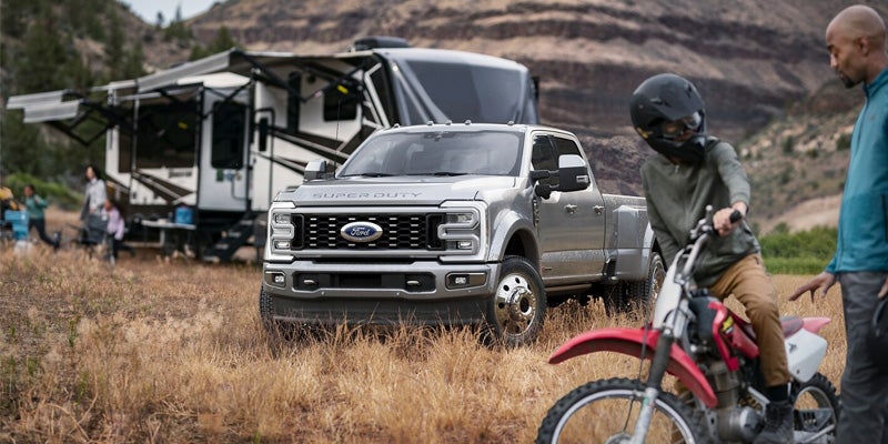 front view of a silver 2024 Ford Super Duty F-250 parked in a field