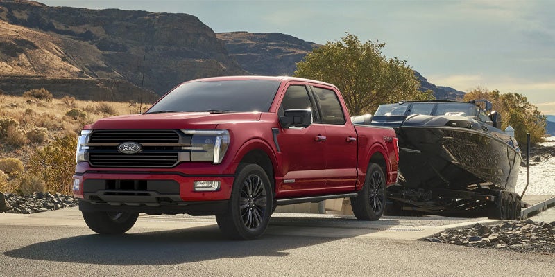a red 2025 Ford F-150 Pulling a Trailor