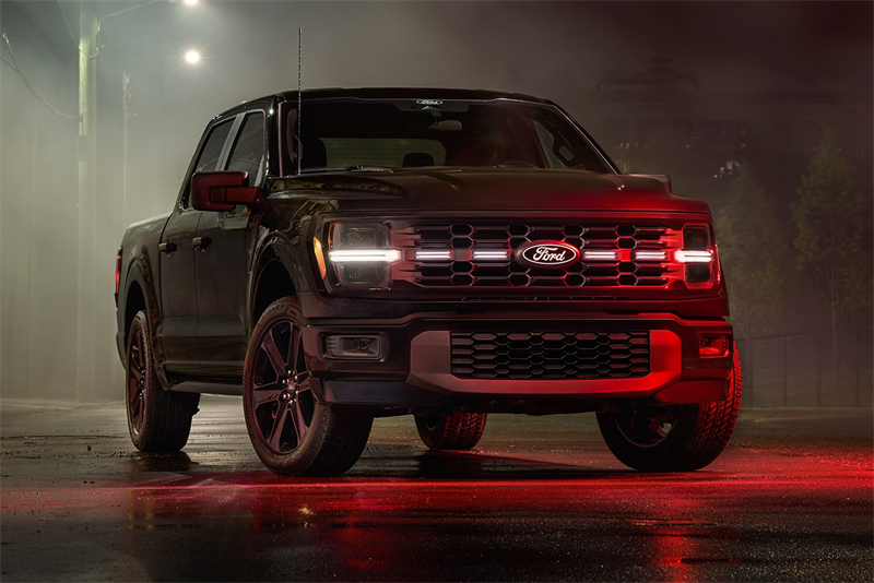 Black 2026 Ford F150 parked in dark misty room with red lighting