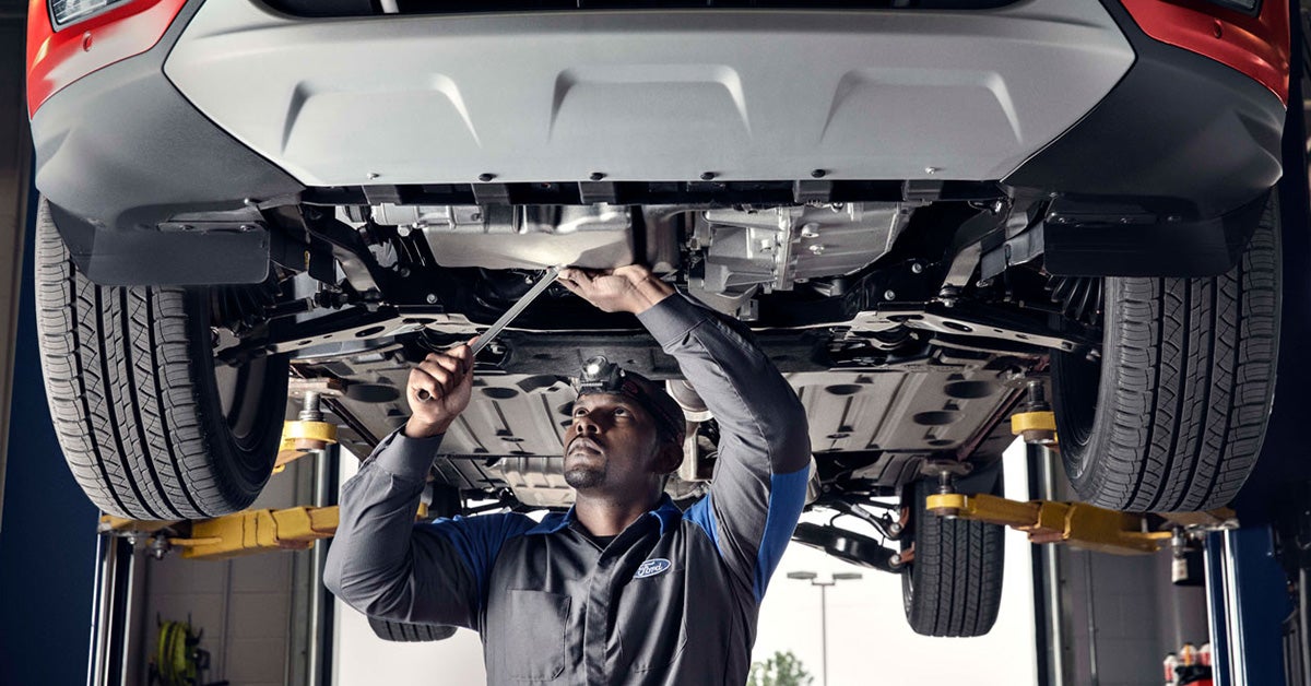 Ford service tech working under a car